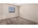 Neutral bedroom with a window letting in natural light and carpeted flooring at 12056 W Melinda Ln, Sun City, AZ 85373