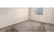Cozy bedroom with a window for natural light and neutral carpet flooring at 12056 W Melinda Ln, Sun City, AZ 85373