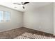 Carpeted bedroom with ceiling fan, a window, and neutral paint, offering a blank canvas at 12056 W Melinda Ln, Sun City, AZ 85373