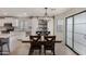 Dining area featuring an elegant chandelier, sliding barn doors and tile flooring at 12056 W Melinda Ln, Sun City, AZ 85373
