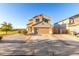 Two-story stucco home with a two-car garage, desert landscaping and a paved driveway at 12056 W Melinda Ln, Sun City, AZ 85373