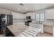 Bright kitchen features white cabinets, granite countertops, tile backsplash, and stainless steel appliances at 12056 W Melinda Ln, Sun City, AZ 85373