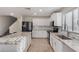 Bright kitchen featuring granite counters, white cabinets, tiled backsplash, and stainless steel appliances at 12056 W Melinda Ln, Sun City, AZ 85373