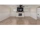 Living room featuring an electric fireplace, a ceiling fan and wainscoting at 12056 W Melinda Ln, Sun City, AZ 85373