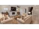 Cozy living room with a fireplace, wainscoting, tile floors, and neutral decor at 12056 W Melinda Ln, Sun City, AZ 85373