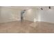 Open living room with tile floors, shiplap accent wall, staircase and doorway at 12056 W Melinda Ln, Sun City, AZ 85373