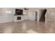Open concept living room features an electric fireplace, wainscoting and a staircase at 12056 W Melinda Ln, Sun City, AZ 85373