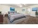 Relaxing main bedroom suite with a blue bed, coordinated art, and a doorway to an ensuite bathroom at 12056 W Melinda Ln, Sun City, AZ 85373