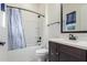 Modern bathroom featuring a shower-tub combo, dark wood vanity, and matching mirror at 1331 E La Mirada Dr, Phoenix, AZ 85042