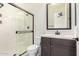 Stylish bathroom showcasing glass-enclosed shower, dark wood vanity, and a sleek mirror at 1331 E La Mirada Dr, Phoenix, AZ 85042
