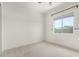 Bright bedroom features a large window with blinds, neutral carpet, and baseboards at 1331 E La Mirada Dr, Phoenix, AZ 85042