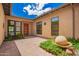 Charming desert courtyard with water feature, tiled flooring, garden plants, and dark trim at 1331 E La Mirada Dr, Phoenix, AZ 85042