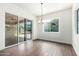 Bright dining area with wood-look tile floors, modern lighting, and sliding glass door to backyard patio at 1331 E La Mirada Dr, Phoenix, AZ 85042