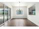 Dining area featuring wood-look tile flooring, modern chandelier, and views of the landscaped backyard at 1331 E La Mirada Dr, Phoenix, AZ 85042