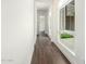 Hallway with dark wood-look tile flooring and a large window overlooking the courtyard at 1331 E La Mirada Dr, Phoenix, AZ 85042
