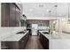 Beautiful kitchen features an island, stainless steel appliances and dark wood cabinets at 1331 E La Mirada Dr, Phoenix, AZ 85042