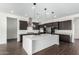 Kitchen features an island, stainless steel appliances and dark wood cabinets at 1331 E La Mirada Dr, Phoenix, AZ 85042