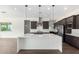 Modern kitchen island and stainless appliances paired with dark wood cabinets at 1331 E La Mirada Dr, Phoenix, AZ 85042