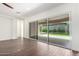 Bright living room with wood-look tile floors leading to a large sliding glass door and patio at 1331 E La Mirada Dr, Phoenix, AZ 85042
