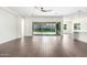Open living room with wood-look tile flooring and views of outdoor space through sliding glass doors at 1331 E La Mirada Dr, Phoenix, AZ 85042