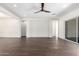Open-concept living space with sleek wood-look tile floors and a contemporary ceiling fan at 1331 E La Mirada Dr, Phoenix, AZ 85042