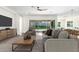Bright living room with ceiling fan, modern furniture, and sliding glass doors to the backyard at 1331 E La Mirada Dr, Phoenix, AZ 85042