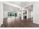 Spacious open-concept living space with wood-look tile floors and seamless flow to kitchen and patio at 1331 E La Mirada Dr, Phoenix, AZ 85042