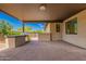 Covered patio featuring an outdoor kitchen with built-in grill and stone pavers at 1331 E La Mirada Dr, Phoenix, AZ 85042
