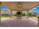 Covered patio featuring a stone entertainment center and television at 1331 E La Mirada Dr, Phoenix, AZ 85042