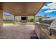 Spacious outdoor living area with a covered patio, entertainment center, and grill at 1331 E La Mirada Dr, Phoenix, AZ 85042