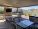 Covered patio with ample seating, an outdoor TV, and manicured landscaping, perfect for entertaining at 1331 E La Mirada Dr, Phoenix, AZ 85042