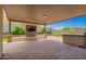 Covered patio with a stone entertainment center and television at 1331 E La Mirada Dr, Phoenix, AZ 85042