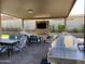 Covered patio featuring a built-in barbecue, dining area, and entertainment space with manicured landscaping at 1331 E La Mirada Dr, Phoenix, AZ 85042