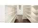 Pantry featuring white walls, dark wood floors, and white shelving at 1331 E La Mirada Dr, Phoenix, AZ 85042