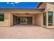 Spacious covered patio with a fan and large sliding glass doors leading to the interior at 1331 E La Mirada Dr, Phoenix, AZ 85042