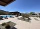 Relaxing community pool area with lounge chairs, shade structure, and beautiful desert landscaping at 1331 E La Mirada Dr, Phoenix, AZ 85042