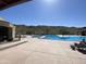 A stunning community pool with pristine blue water, surrounded by comfortable seating and desert landscaping at 1331 E La Mirada Dr, Phoenix, AZ 85042