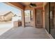 Spacious covered back patio with built-in grill and access to the home's interior at 13542 W Port Au Prince Ln, Surprise, AZ 85379