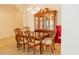 Elegant dining room with classic china cabinet, dining set, and chandelier, perfect for hosting dinners at 13542 W Port Au Prince Ln, Surprise, AZ 85379