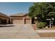 Charming single-story home features a spacious three-car garage and well-manicured front yard at 13542 W Port Au Prince Ln, Surprise, AZ 85379