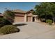 Charming single-story home features a spacious three-car garage and a shade tree in front yard at 13542 W Port Au Prince Ln, Surprise, AZ 85379