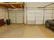 Garage featuring two overhead doors and a parked car at 13542 W Port Au Prince Ln, Surprise, AZ 85379