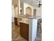 Kitchen featuring a breakfast bar, laminate countertops, white appliances, and a convenient dishwasher for easy cleanup at 13542 W Port Au Prince Ln, Surprise, AZ 85379
