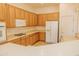Bright kitchen features a breakfast bar, matching appliances, and ample cabinet space at 13542 W Port Au Prince Ln, Surprise, AZ 85379