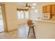Tile kitchen with breakfast bar, seating, tile flooring, built-in appliances, and a view of the back yard at 13542 W Port Au Prince Ln, Surprise, AZ 85379