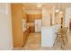 Spacious kitchen featuring a breakfast bar with seating and modern appliances and oak cabinets at 13542 W Port Au Prince Ln, Surprise, AZ 85379