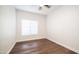 Bedroom with wood-look floors, window and a ceiling fan at 1411 E Orangewood Ave # 123, Phoenix, AZ 85020