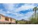 Exterior view of the home, showcasing garage access, tile roof, and mountain views at 1411 E Orangewood Ave # 123, Phoenix, AZ 85020
