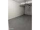 The garage has a gray epoxy floor and white walls at 1411 E Orangewood Ave # 123, Phoenix, AZ 85020