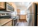 Well-equipped kitchen with stainless steel appliances and light wood cabinetry at 1411 E Orangewood Ave # 123, Phoenix, AZ 85020